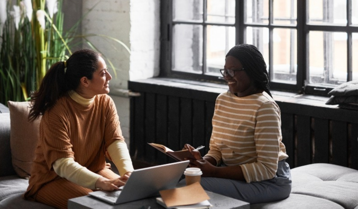 2 women talking and smiling